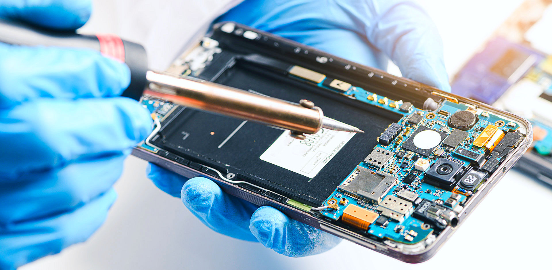 technician soldering a phone